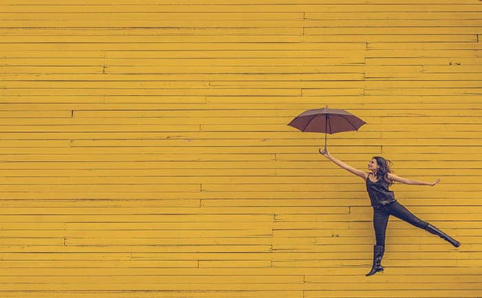 event-managers-yellow-wall-woman-umbrella